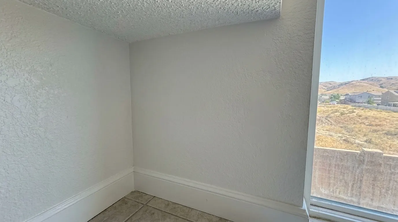 Same bathroom wall clean and repainted after mold remediation